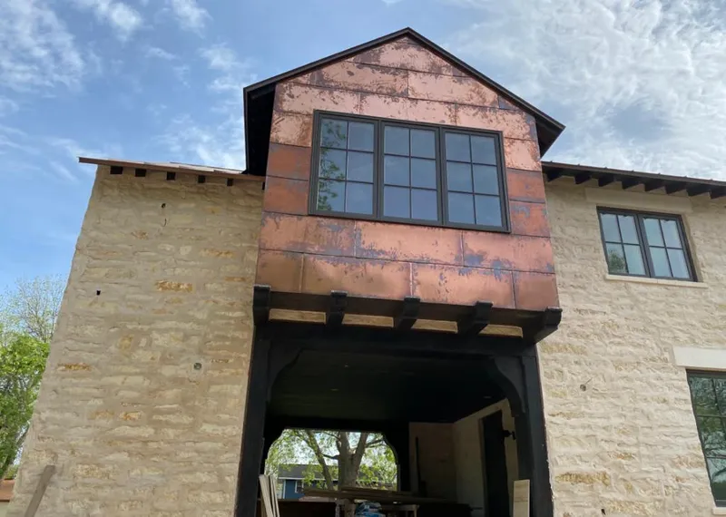 Copper metal panel facade on a stone building for Skylight Installation in San Antonio