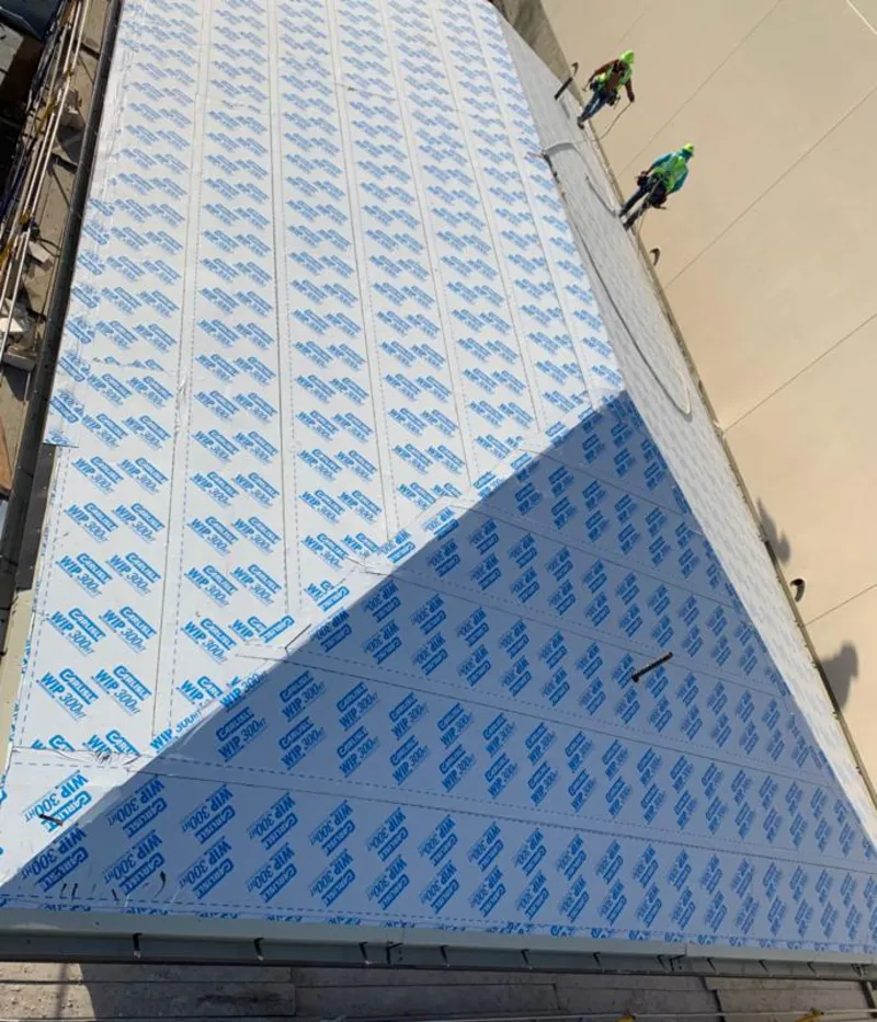 Professional roofers installing underlayment on a metal roof in San Antonio